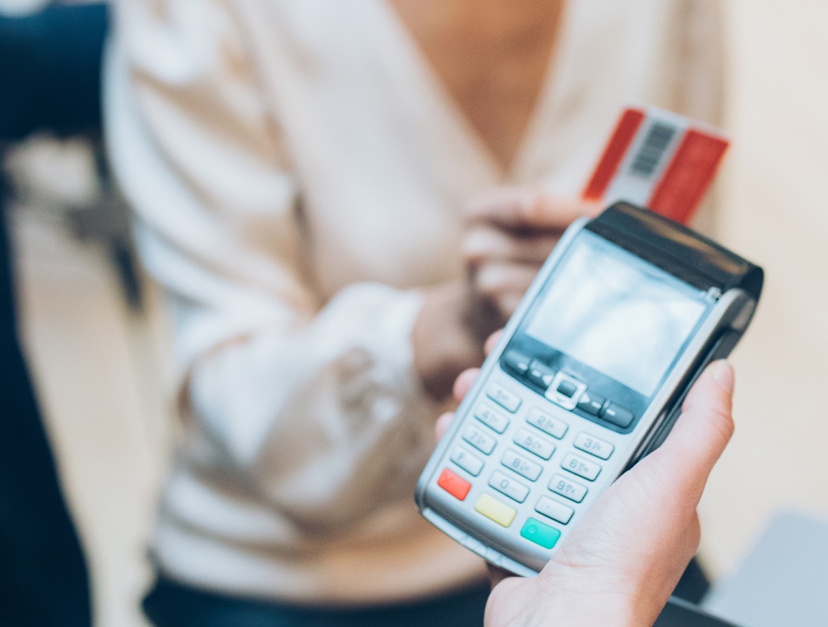photo - hand holding credit card machine